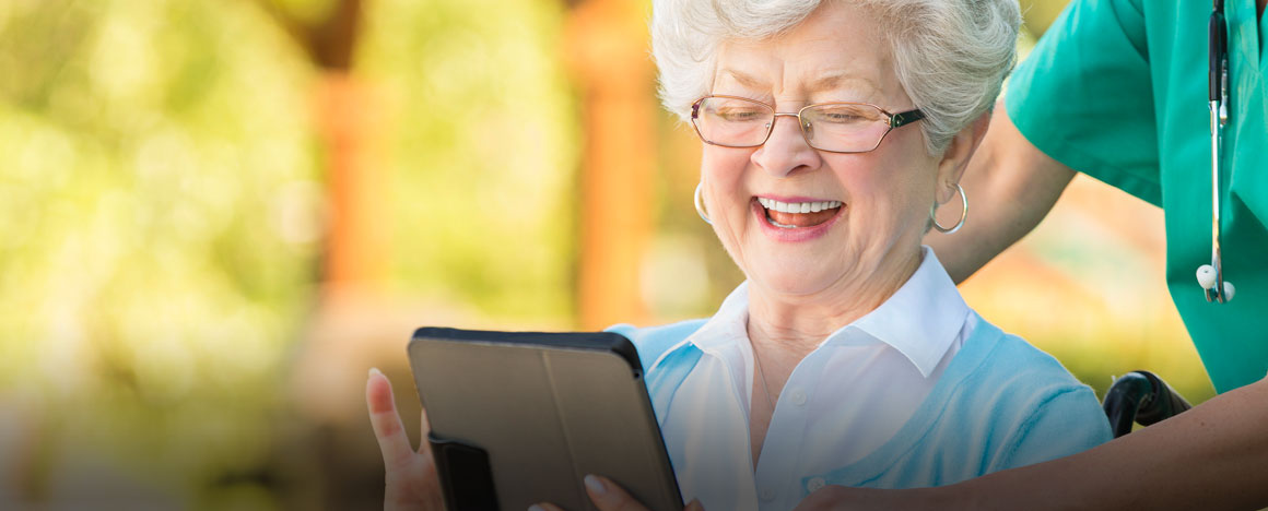 Proud-senior-woman-learns-to-use-a-digital-tablet